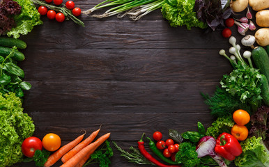 Frame of fresh vegetables on wooden background with copy space