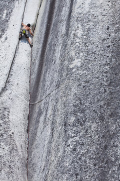 A strong male climber climbing Crescent Crack 10d, Squamish, BC