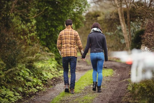 Couple walking on dirt track