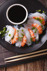 Shirataki Noodles with shrimp and green onions close-up. vertical top view
