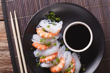 Japanese food: Shirataki with prawns, spring onions and soy sauce close-up. horizontal top view
