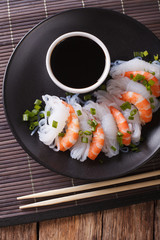 Japanese food: Shirataki with prawns, spring onions and soy sauce close-up. vertical top view
