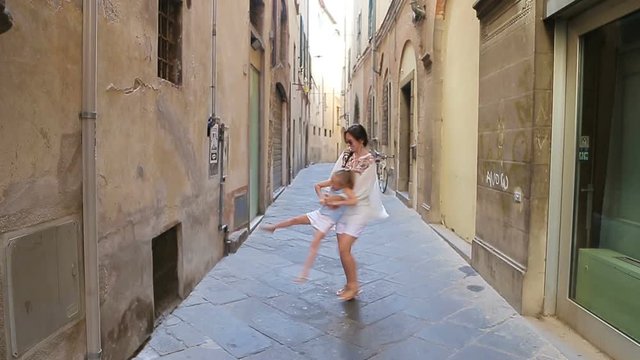 Family in Europe. Happy mother and little adorable girl having fun in Rome during summer italian vacation