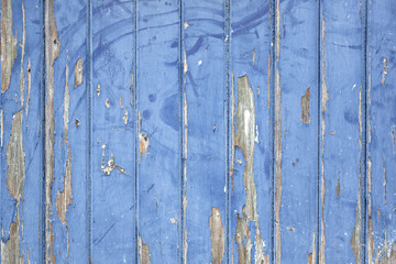 peeling blue paint on wooden door or fence