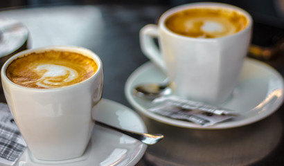 Two coffee cups on table
