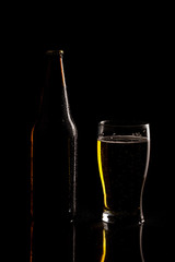 Beer bottle and glass silhouette isolated on black background