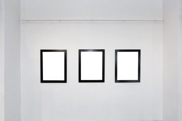 exhibition gallery interior with empty frames on wall