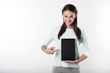 Cheerful delighted woman holding tablet