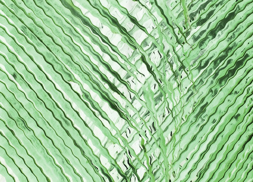 Green background made of pattern with palm tree leaves