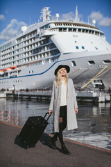 beautiful woman with a baggage at sea cruise liner
