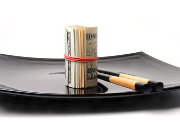 pack of dollars is twisted into a roll