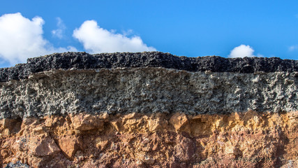 The curb erosion from storms. To indicate the layers of soil and