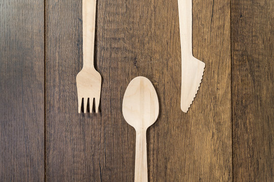 Set Of Wooden Spoon Fork Knife On Wooden Background