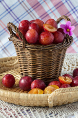 Ripe plum pink in a wooden basket