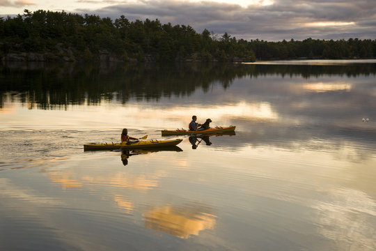 Young couple kayaking on Gull Lake near Gravenhurst, Ontario, Canada.