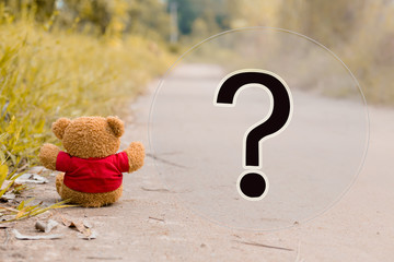 lonely teddy bear with big question mark