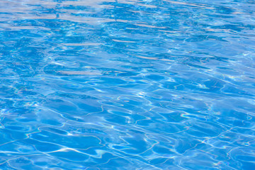 Blue swimming pool rippled water.