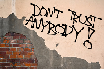 Do not Trust Anybody - Handwritten graffiti sprayed on the wall, anarchist aesthetics. Appeal to be...