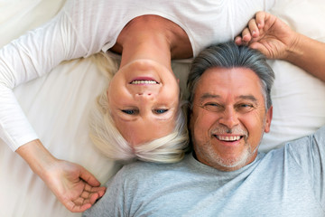 Senior couple lying in bed together
