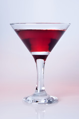 Martini glass  with color drink close-up, decoration on the edge of a white crumb