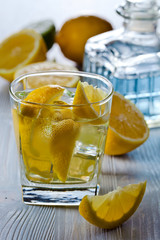 Gin with tonic , lemon and ice