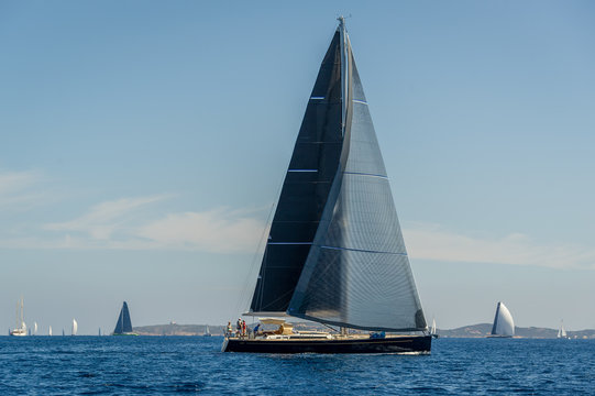 Fototapeta Luxury big sailing yacht with black sails.