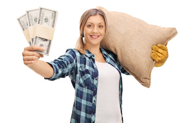 Farmer carrying a sack and holding money stacks