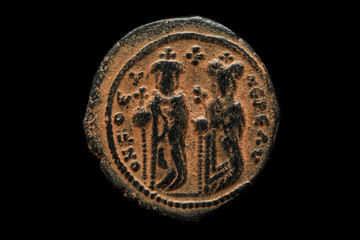 Ancient copper coin with figures of rulers