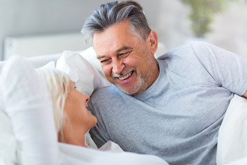 Senior couple lying in bed together
