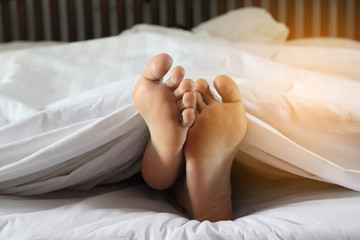 woman feet in bed