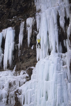 An ice climber making his way up Wiser's Deluxe WI 5, Grand Manan Island, New Brunswick, Canada