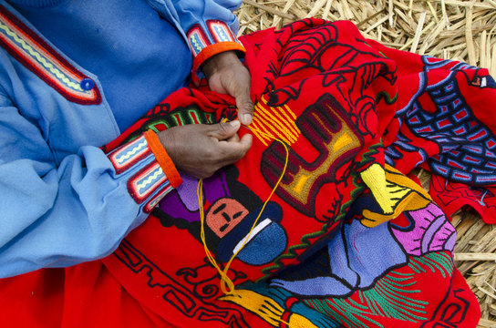 Woman sewing traditional Peruvian clothing, Peru