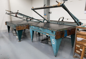 london, england, 10/06/02 Vintage analogue screen printing beds with registration marks at a print...