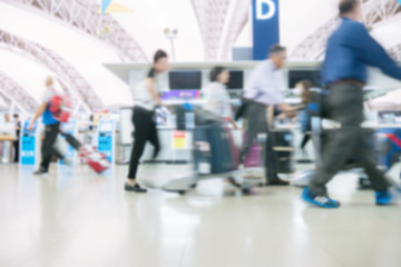 Blurred image of people traveling at airport terminal, People checking in at airport terminal with motion blur