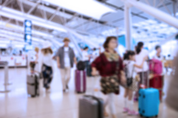 People traveling at airport terminal in blurred motion with retro color effected