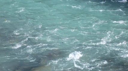 Colorful green water from the Inn river flowing lit by the sunshine