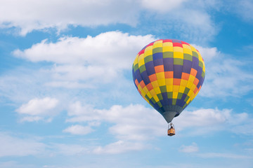 Hot air baloon with clouds blue sky background
