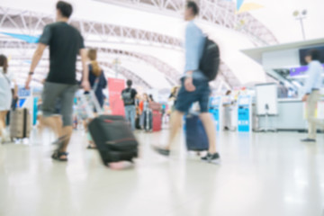 Fototapeta premium Blurred image of people traveling at airport terminal, People checking in at airport terminal with motion blur