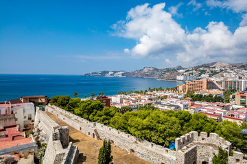 Panoramic view of Almuñécar (Almunecar) with castle walls on a beautiful day, Spain