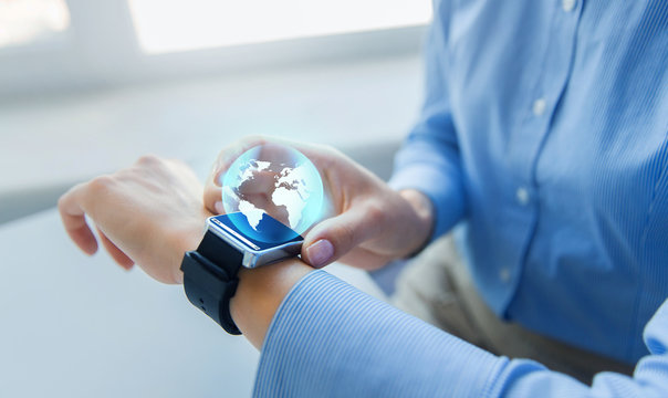 close up of hands and globe hologram on smartwatch - Powered by Adobe