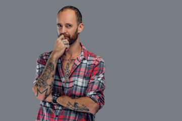 Bearded male with tattoo on his arm.