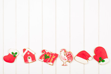Christmas colorful gingerbread cookies on white wooden backgroun