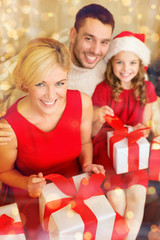 Fototapeta na wymiar happy family opening gift boxes