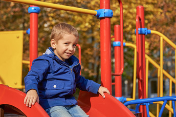 Fototapeta na wymiar Portrait of a happy child on the playground