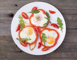 Eggs in pepper on a plate on a table