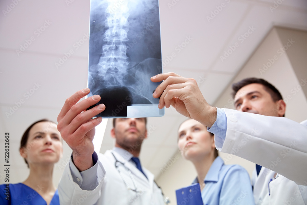 Poster group of medics with spine x-ray scan at hospital