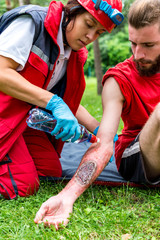 Medical worker helping a victim with third degree burn. Paramedic training, professional injury...