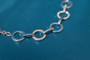 Fototapeta na wymiar silver bracelet on a blue background