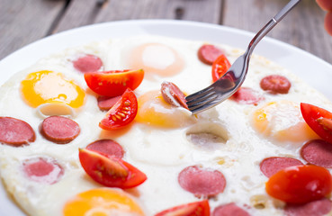 Fried eggs with sausage slices