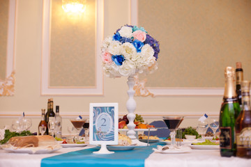 wedding flowers blue color on a table at restaurant